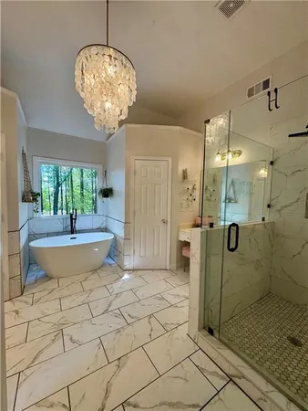 a spacious bathroom with a granite countertop sink a toilet and shower