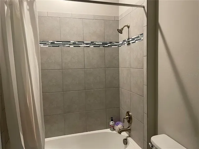 a bathroom with a toilet and a tub