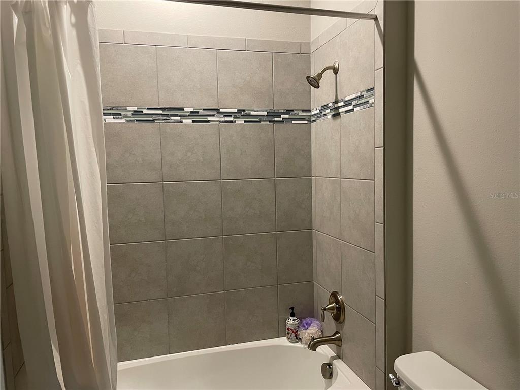 868 Old Windsor Way Spring Hill, FL 34609 - Photo 12 of 20 a bathroom with a toilet and a tub