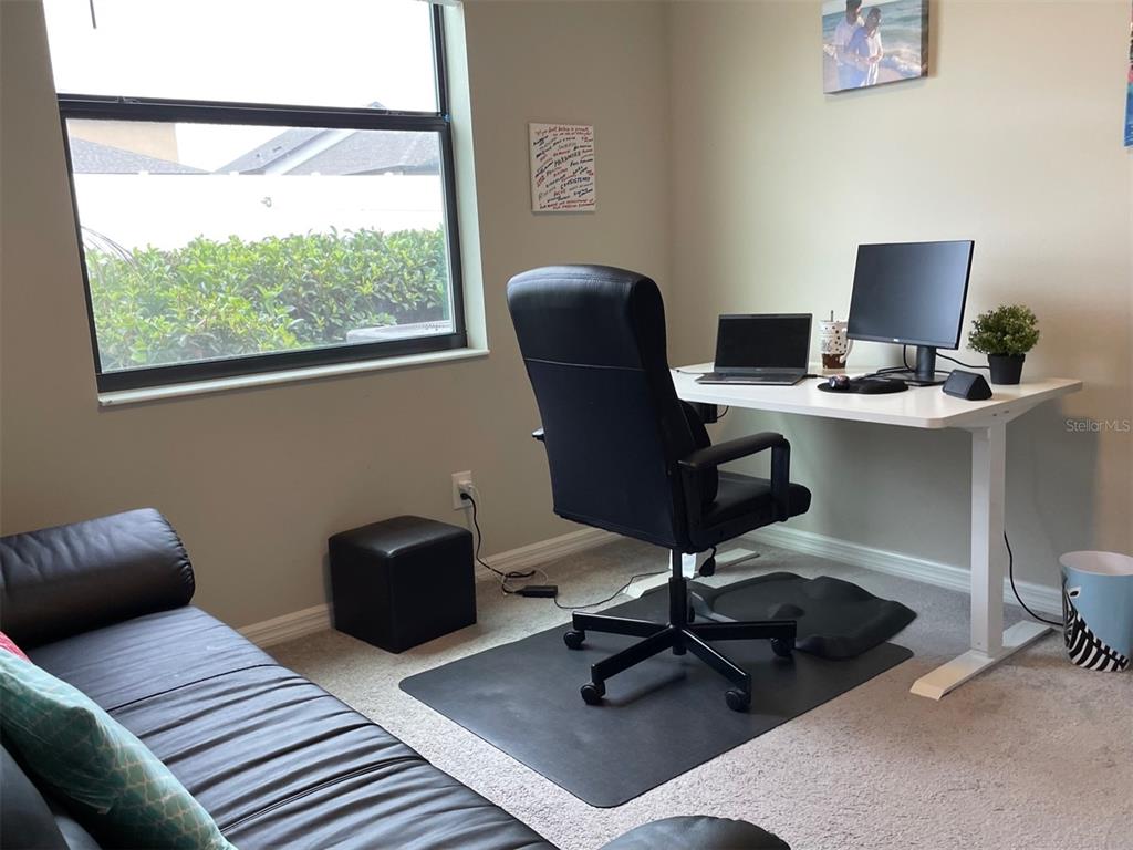 868 Old Windsor Way Spring Hill, FL 34609 - Photo 13 of 20 a view of a workspace with furniture and a window