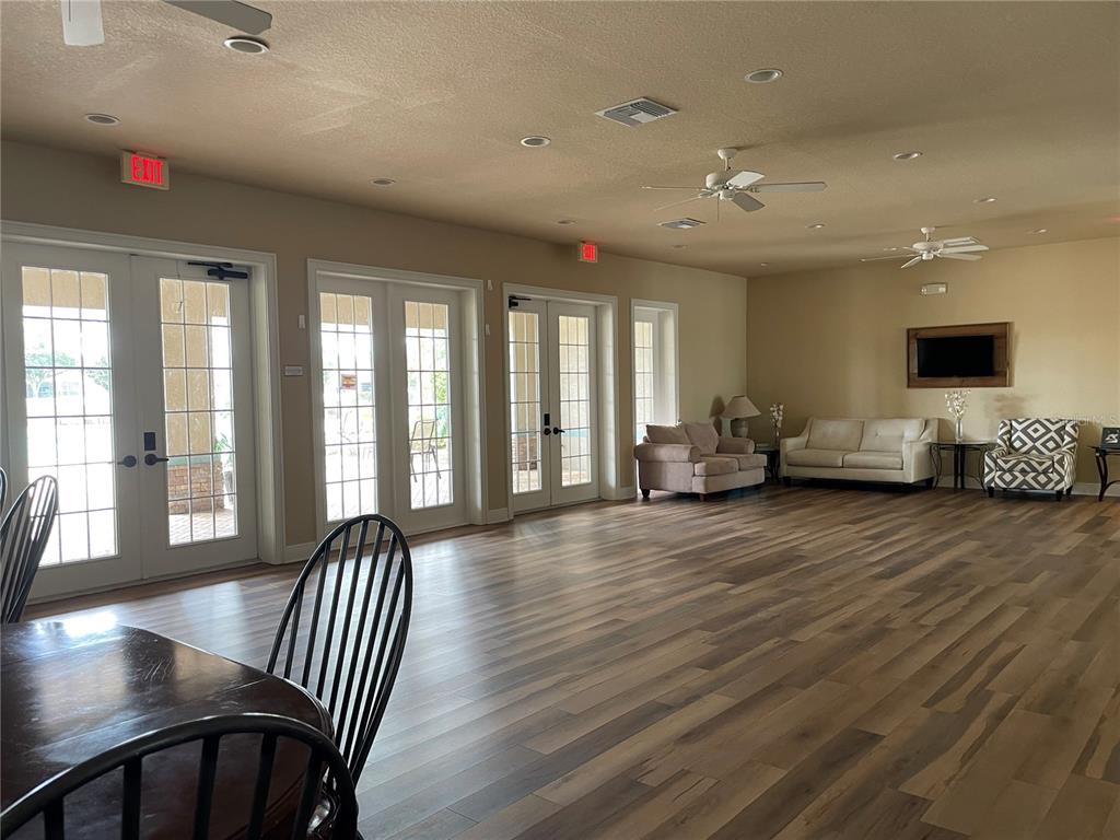 868 Old Windsor Way Spring Hill, FL 34609 - Photo 15 of 20 a view of a livingroom with furniture hardwood floor and windows