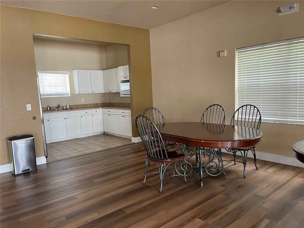 868 Old Windsor Way Spring Hill, FL 34609 - Photo 17 of 20 a view of a dining room with furniture window and wooden floor
