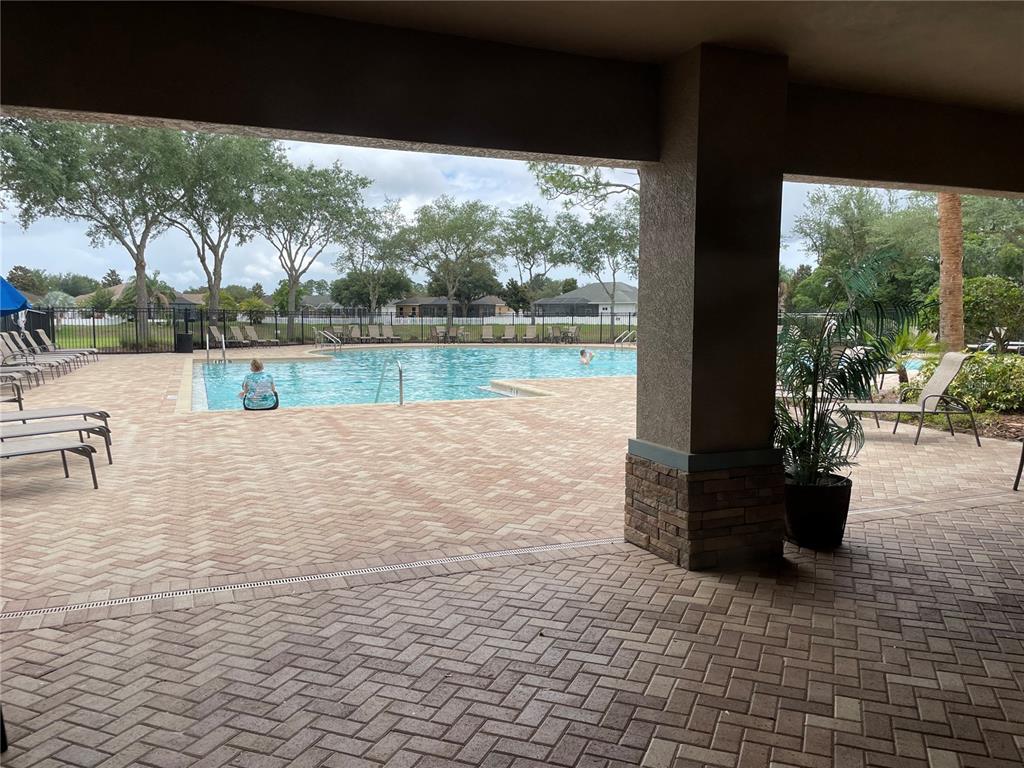 868 Old Windsor Way Spring Hill, FL 34609 - Photo 20 of 20 a view of a lake with a patio