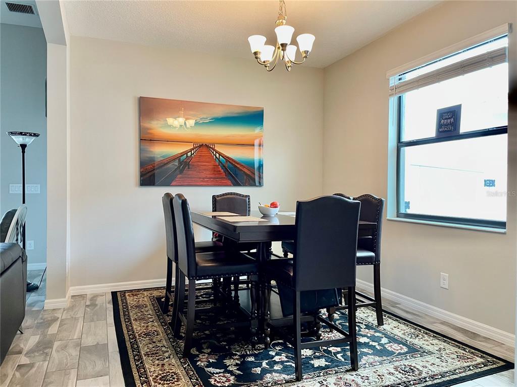 868 Old Windsor Way Spring Hill, FL 34609 - Photo 5 of 20 a view of a dining room with furniture