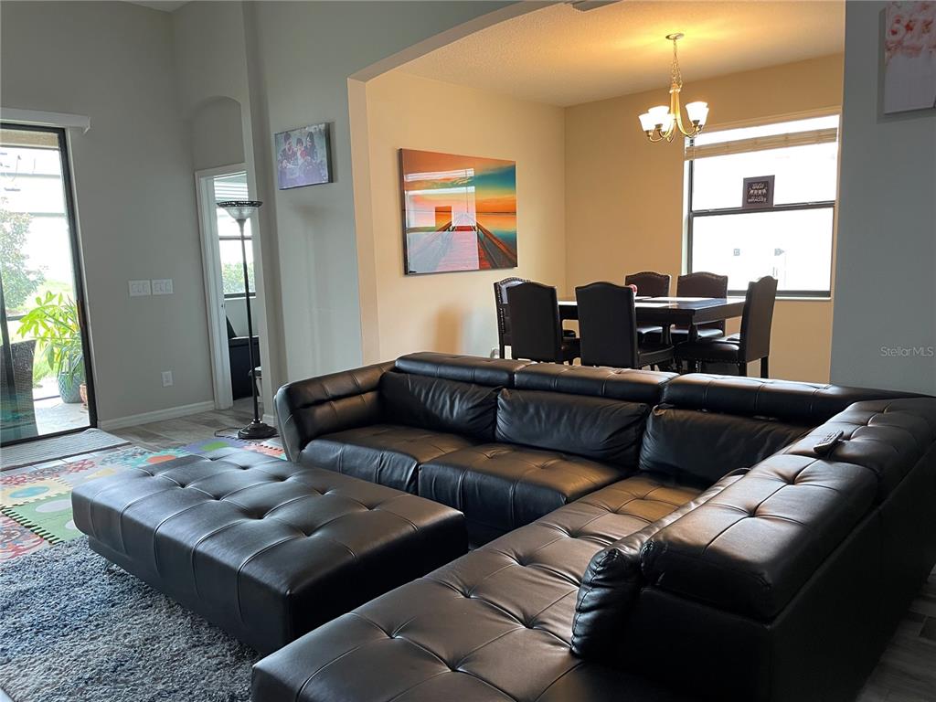 868 Old Windsor Way Spring Hill, FL 34609 - Photo 6 of 20 a living room with furniture and wooden floor