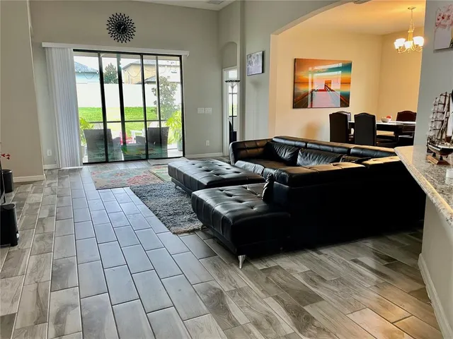 a living room with furniture and large windows