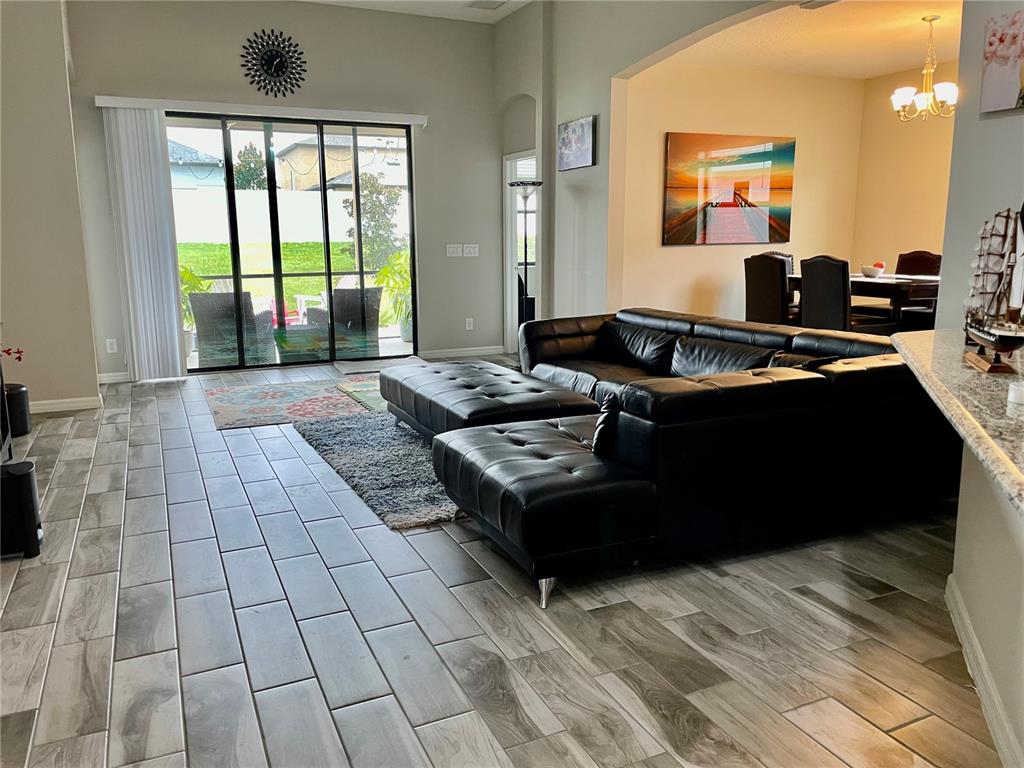 868 Old Windsor Way Spring Hill, FL 34609 - Photo 7 of 20 a living room with furniture and large windows