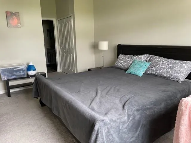 a bedroom with a bed and a chair