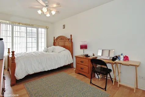 a bedroom with a bed and a desk