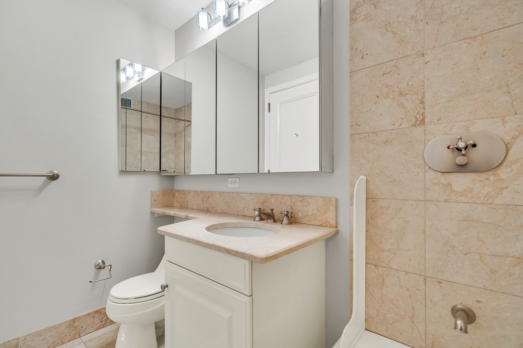 2 Avery Street, Unit 27G Boston, MA 02111 - Photo 13 of 18 a bathroom with a sink and a toilet