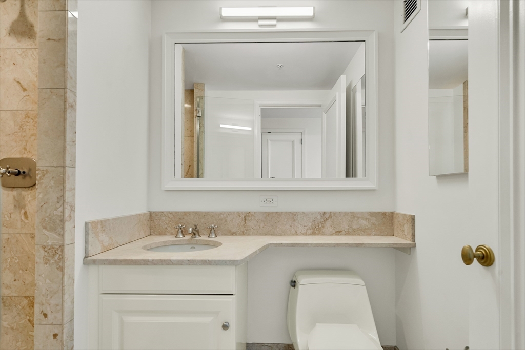 2 Avery Street, Unit 27G Boston, MA 02111 - Photo 9 of 18 a bathroom with a sink and a mirror