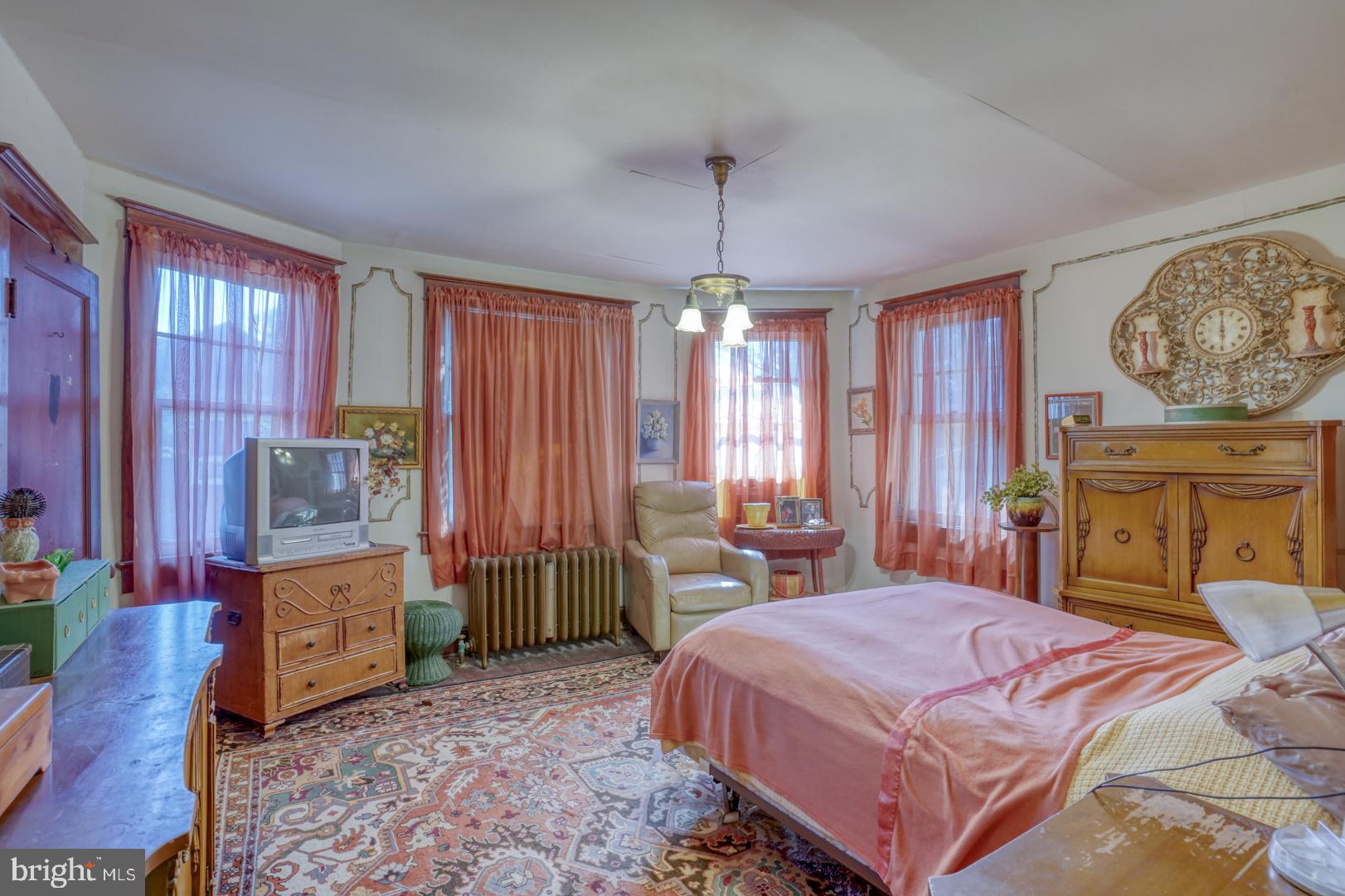 4096 Main Street Trappe, MD 21673 - Photo 47 of 70 a bedroom with a bed and a chandelier