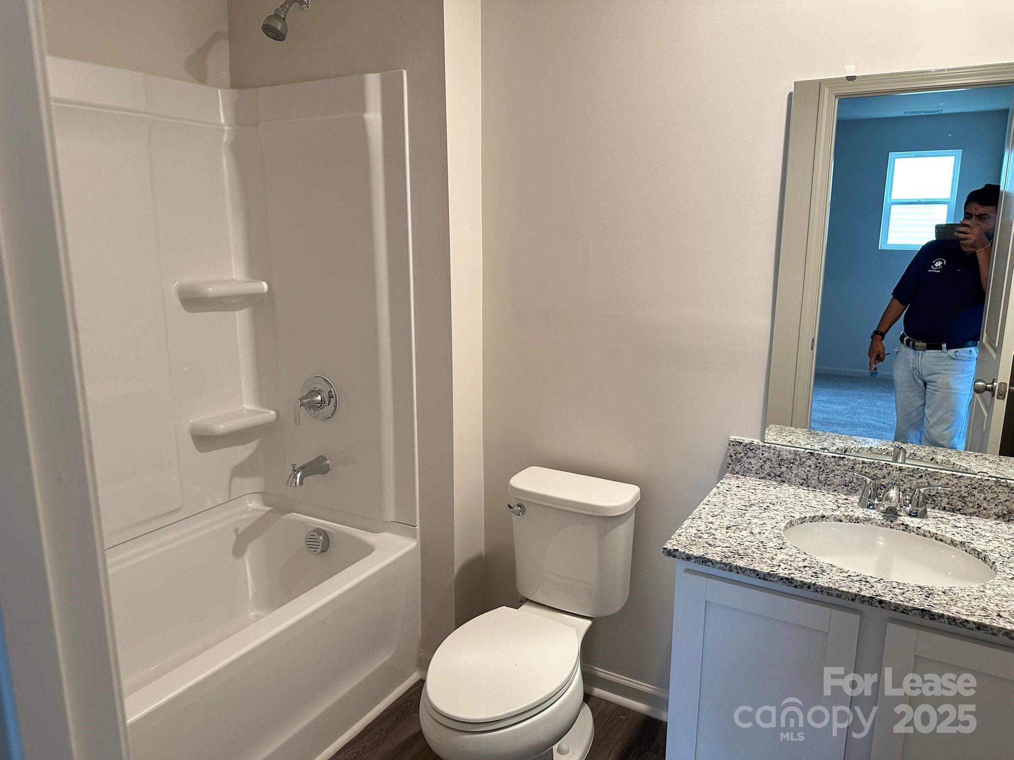 1934 Tranquility Circle, Unit A Newton, NC 28658 - Photo 8 of 10 a bathroom with a granite countertop toilet a sink and bathtub