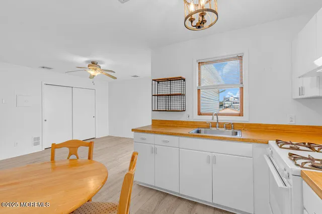 a dining table with a sink and a mirror