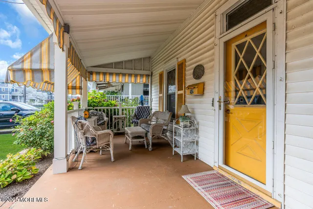 a view of a patio with table and chairs and potted plants