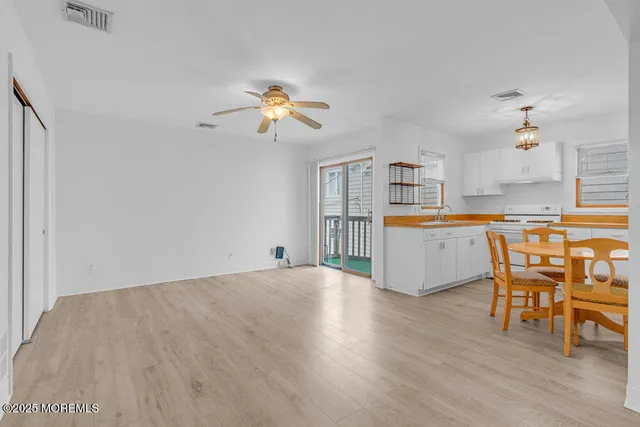 a view of a kitchen and an empty room
