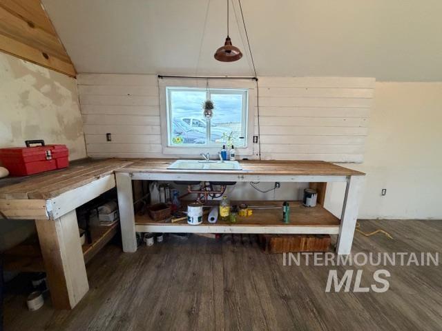 155 Mule Deer Kamiah, ID 83536 - Photo 4 of 25 Interior space with dark wood-style flooring, wood walls, lofted ceiling, and decorative light fixtures