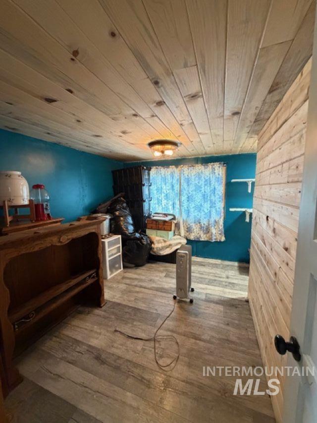 155 Mule Deer Kamiah, ID 83536 - Photo 7 of 25 Bedroom with wood-type flooring, wooden ceiling, and wood walls