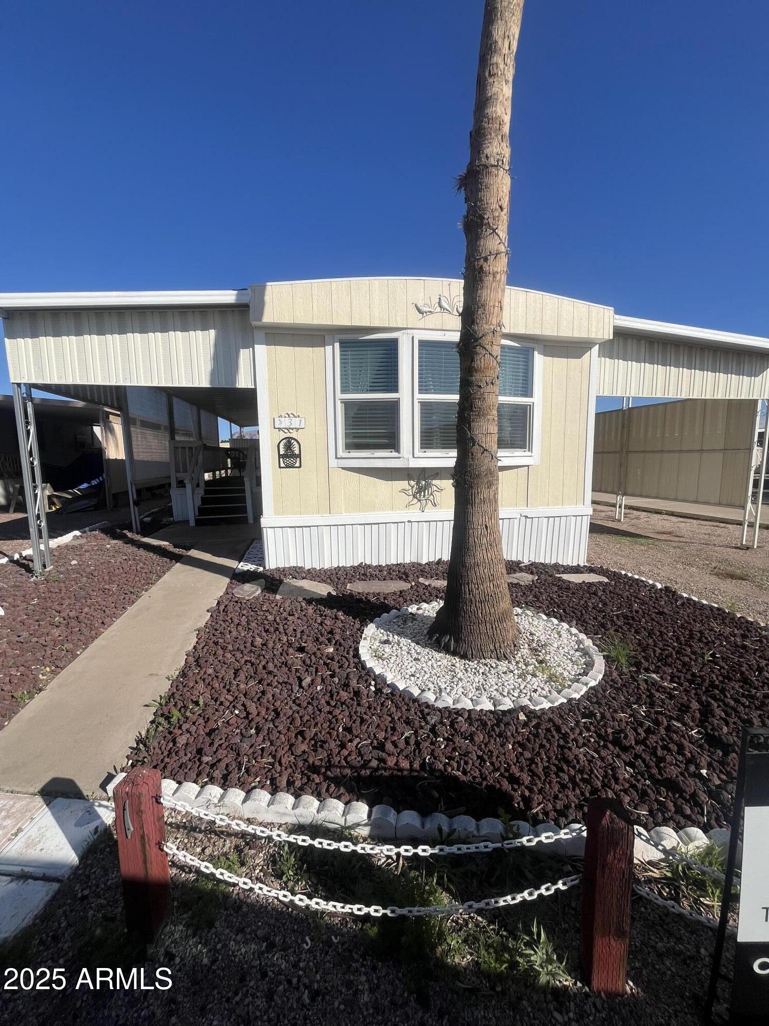2481 West Broadway Avenue, Unit 31 Apache Junction, AZ 85120 - Photo 1 of 12 a front view of a house with garden