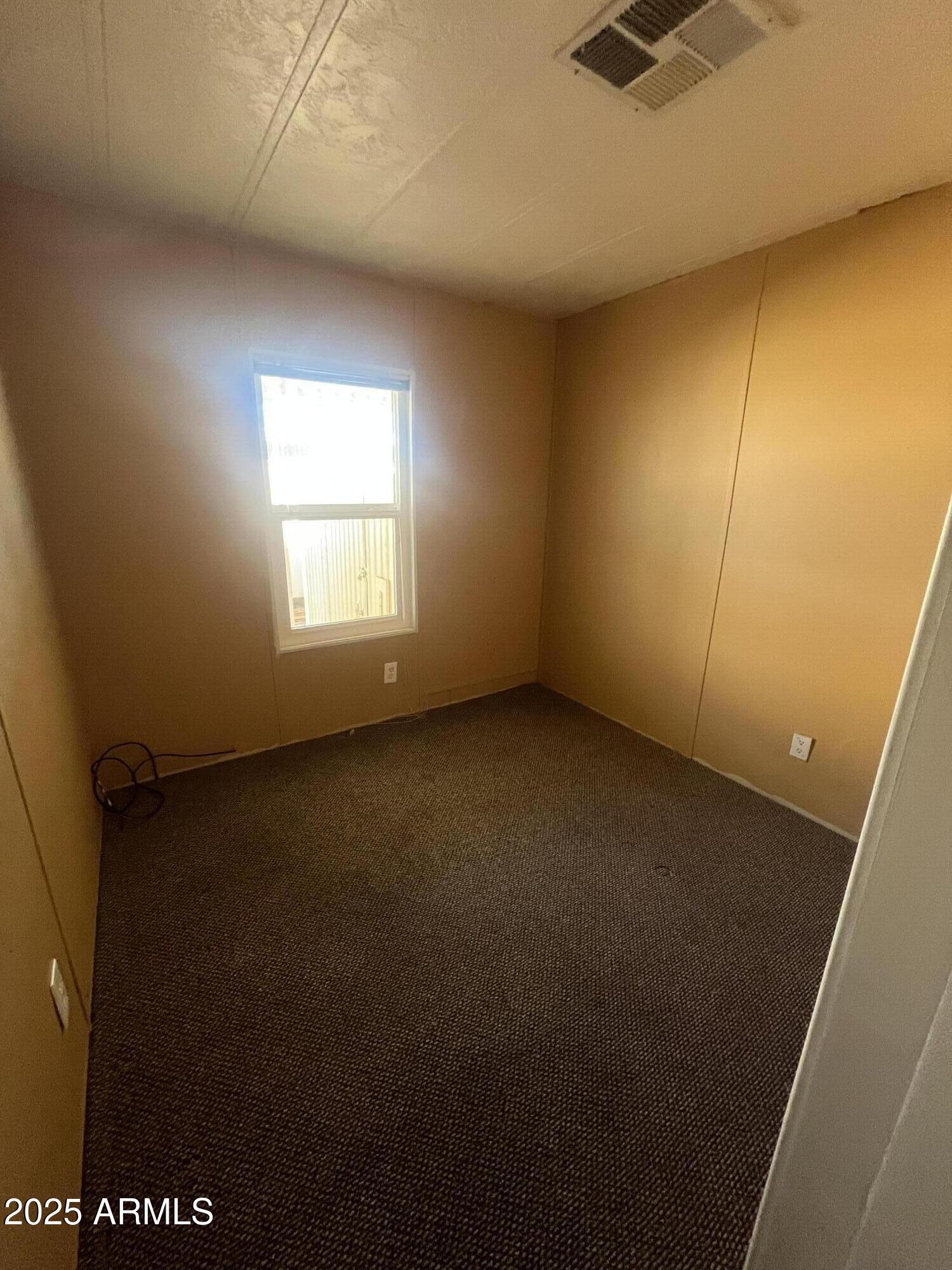 2481 West Broadway Avenue, Unit 31 Apache Junction, AZ 85120 - Photo 11 of 12 an empty room with a window