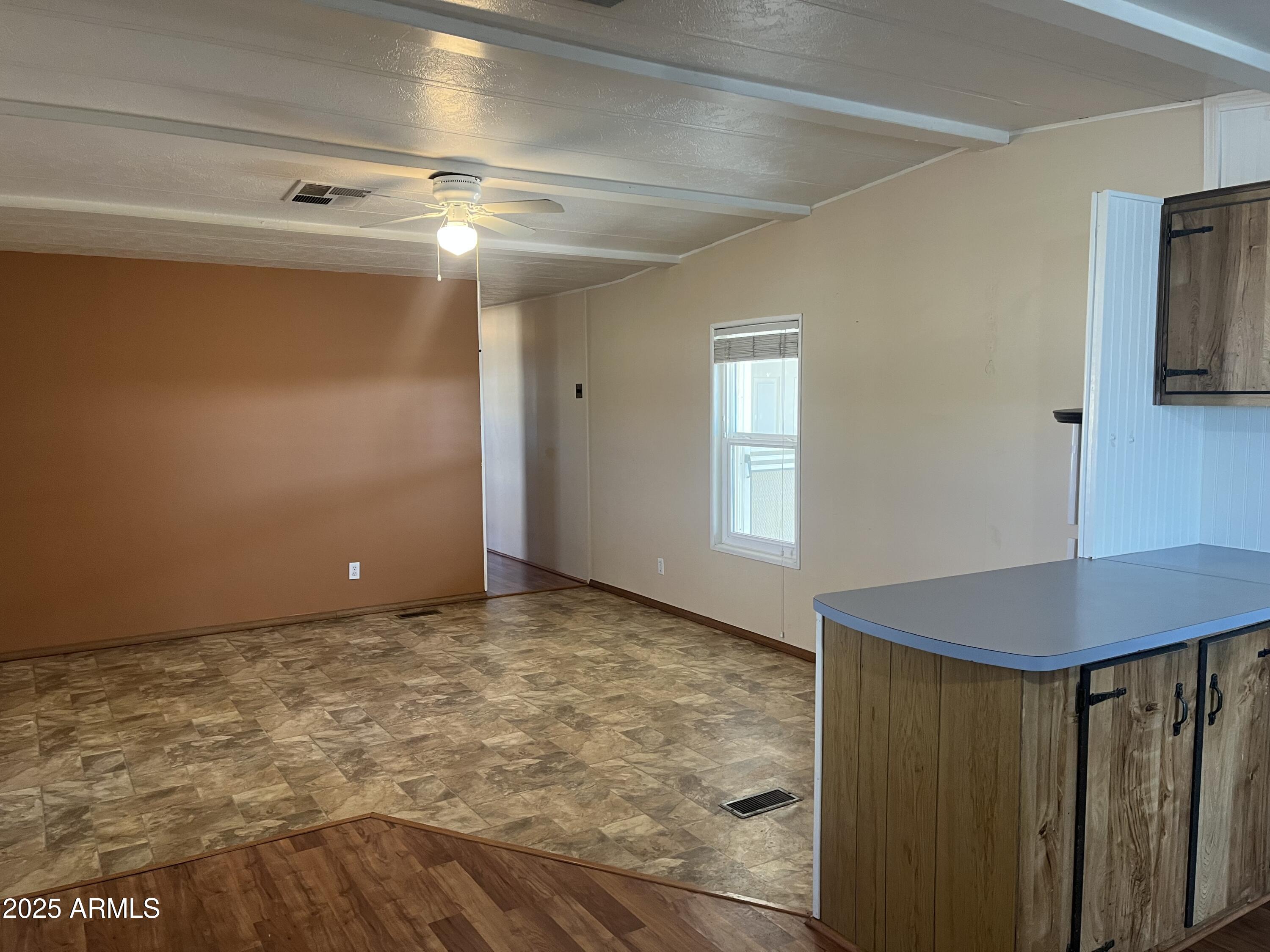 2481 West Broadway Avenue, Unit 31 Apache Junction, AZ 85120 - Photo 7 of 12 a view of a room with a ceiling fan
