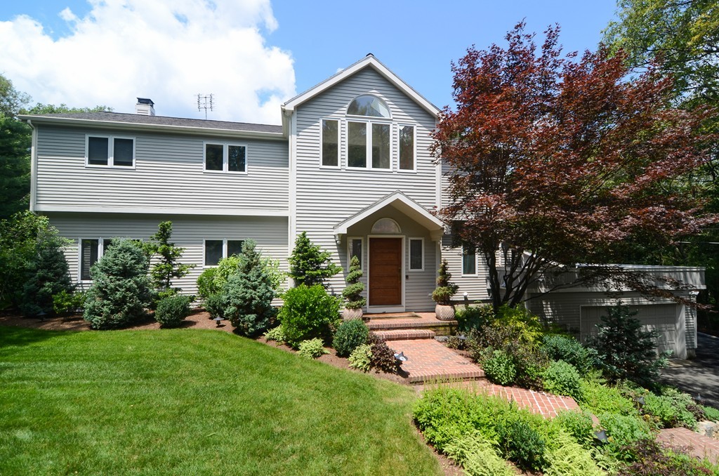 272 Conant Road Weston, MA 02493 - Photo 1 of 16 a front view of a house with a yard and trees