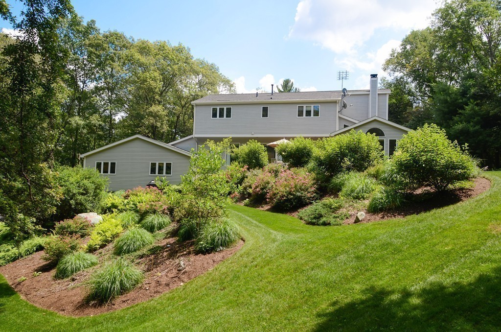 272 Conant Road Weston, MA 02493 - Photo 12 of 16 a view of a house with a yard and potted plants