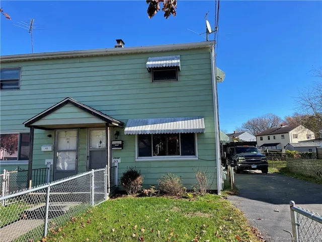 a front view of a house with parking