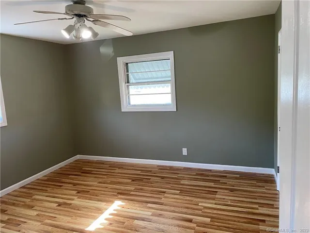 a view of a room with wooden floor and closet