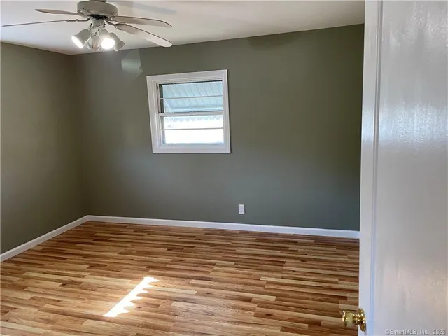a view of room with window and wooden floor