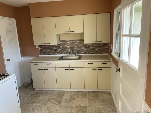 a view of white cabinets and sink