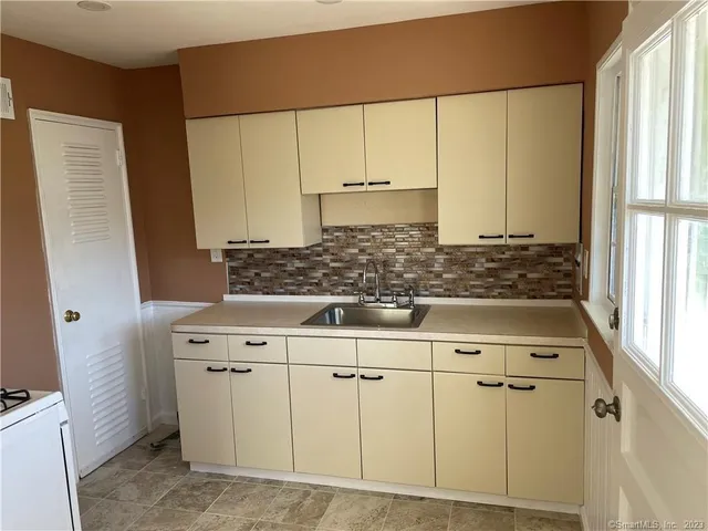a stove top oven sitting inside of a kitchen