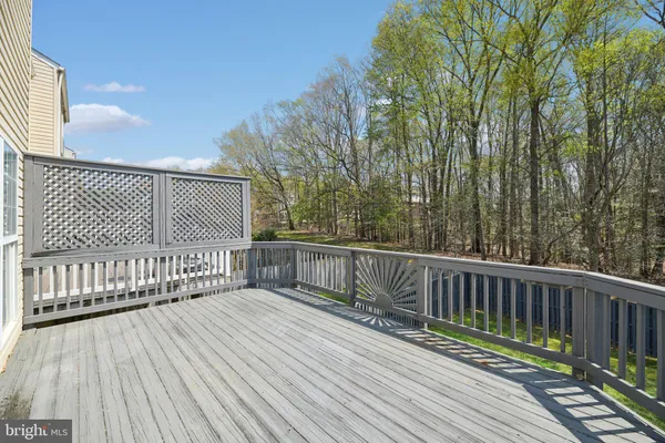 a balcony with wooden floor and fence