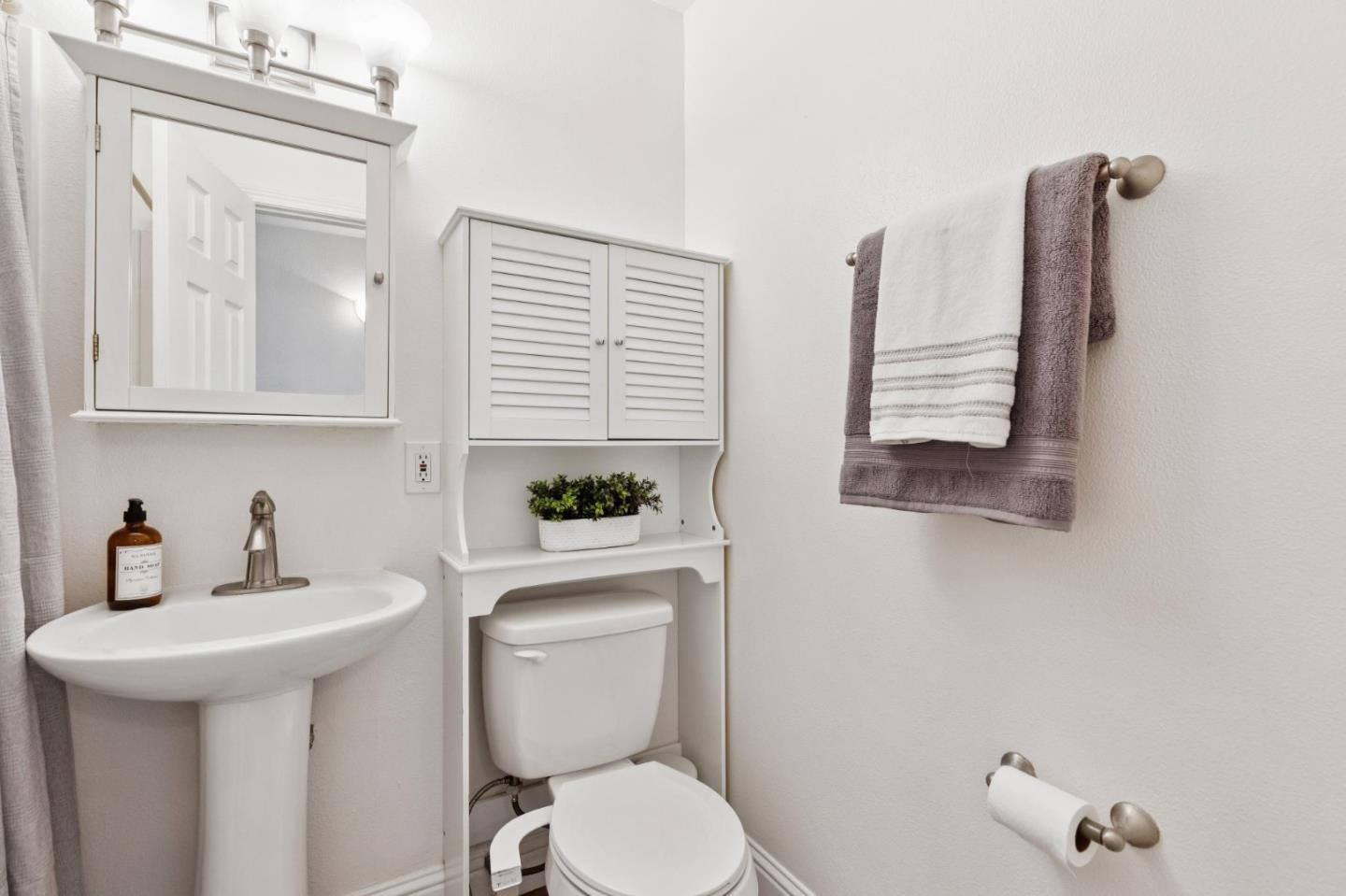 7527 Sutton Lane Dublin, CA 94568 - Photo 31 of 45 a bathroom with a toilet a sink and mirror
