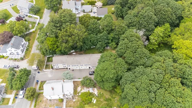 an aerial view of house with yard and swimming pool