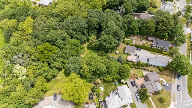 an aerial view of a house with a yard basket ball court and outdoor seating