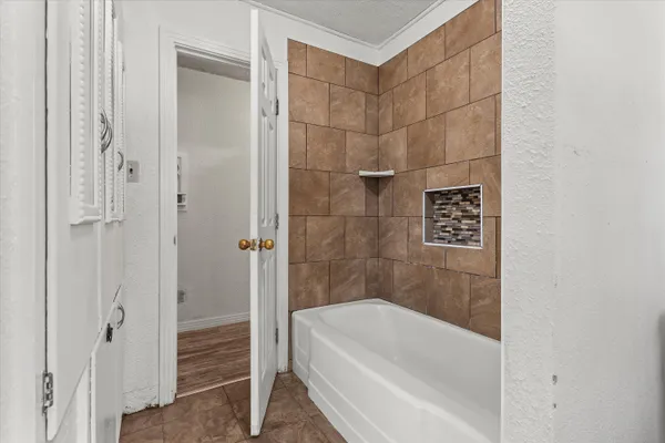 a bathroom with a bathtub and shower