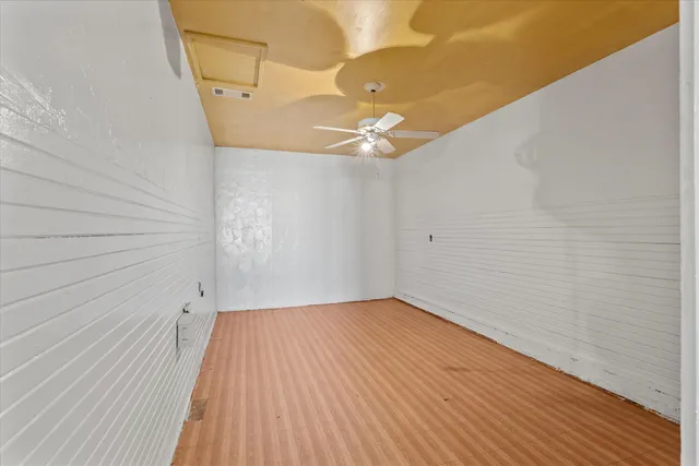 a view of a room with wooden floor