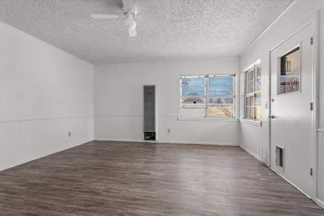 a view of a kitchen with a refrigerator a microwave and a sink