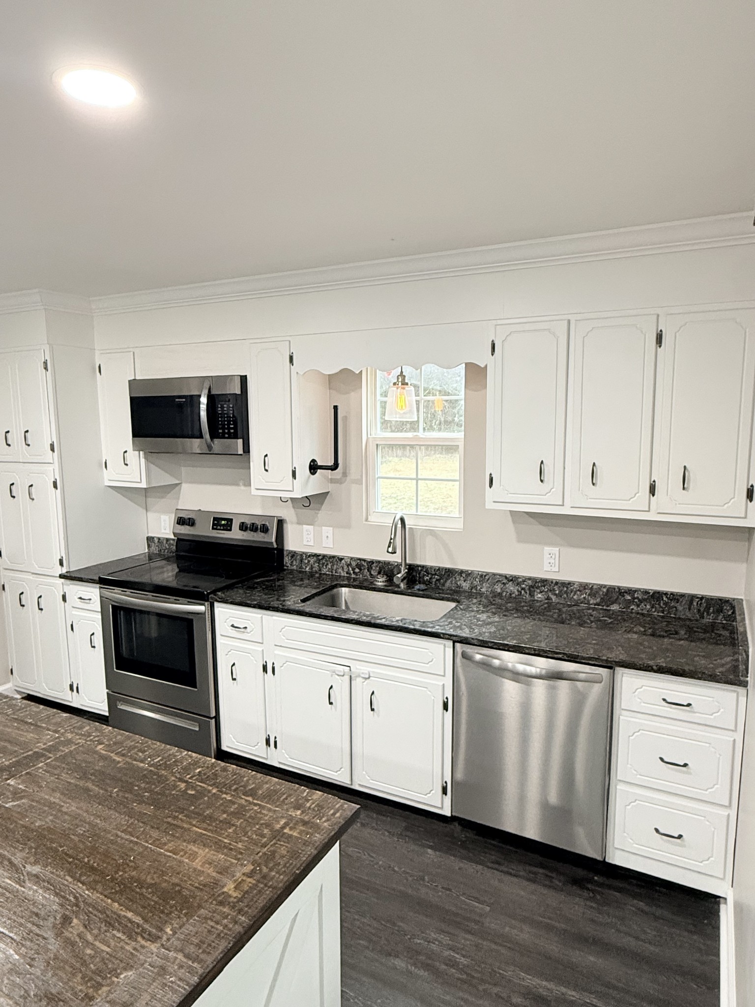 736 Hancock Road Jasper, TN 37347 - Photo 13 of 42 a kitchen with granite countertop a sink a stove and cabinets