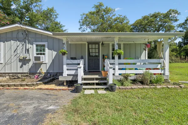 a view of a house with backyard porch and furniture