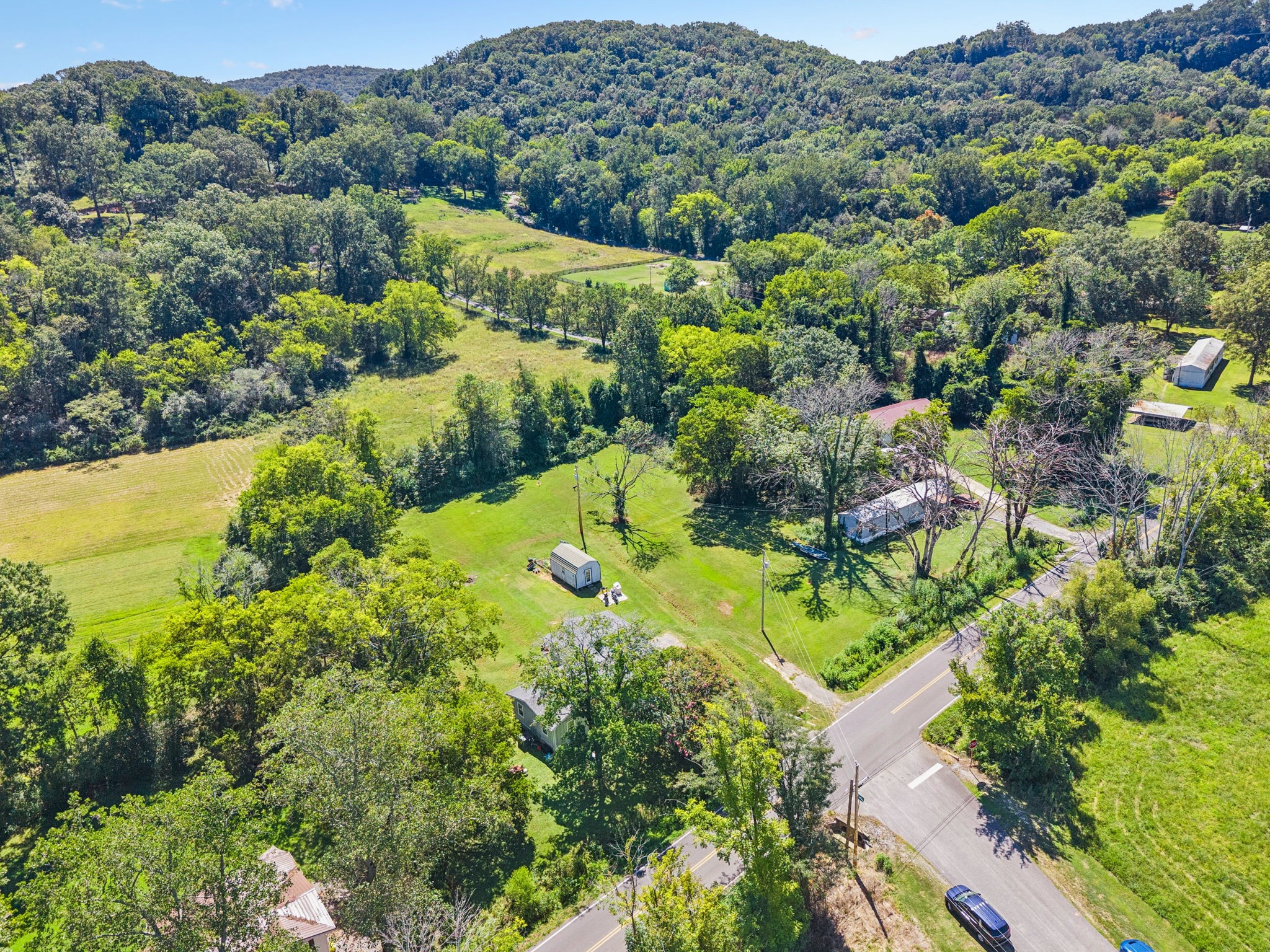 736 Hancock Road Jasper, TN 37347 - Photo 36 of 42 an aerial view of a houses with a lush green hillside