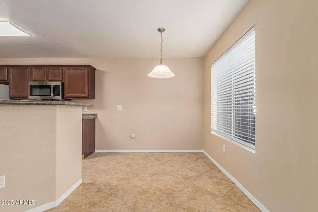 a kitchen with stainless steel appliances granite countertop a stove microwave refrigerator and sink