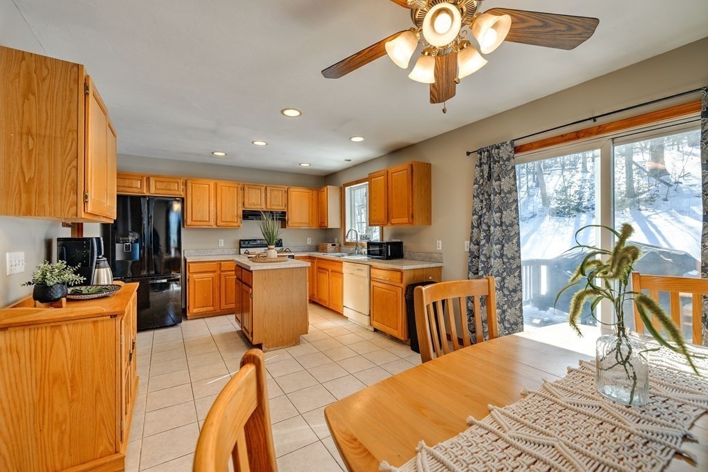 62 Vinton Road Holland, MA 01521 - Photo 11 of 37 a kitchen with a table chairs microwave and cabinets