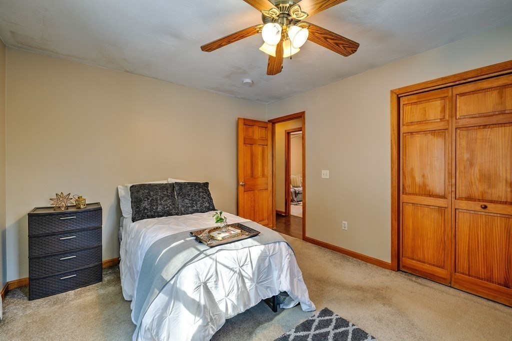 62 Vinton Road Holland, MA 01521 - Photo 20 of 37 a bedroom with a bed and a chandelier