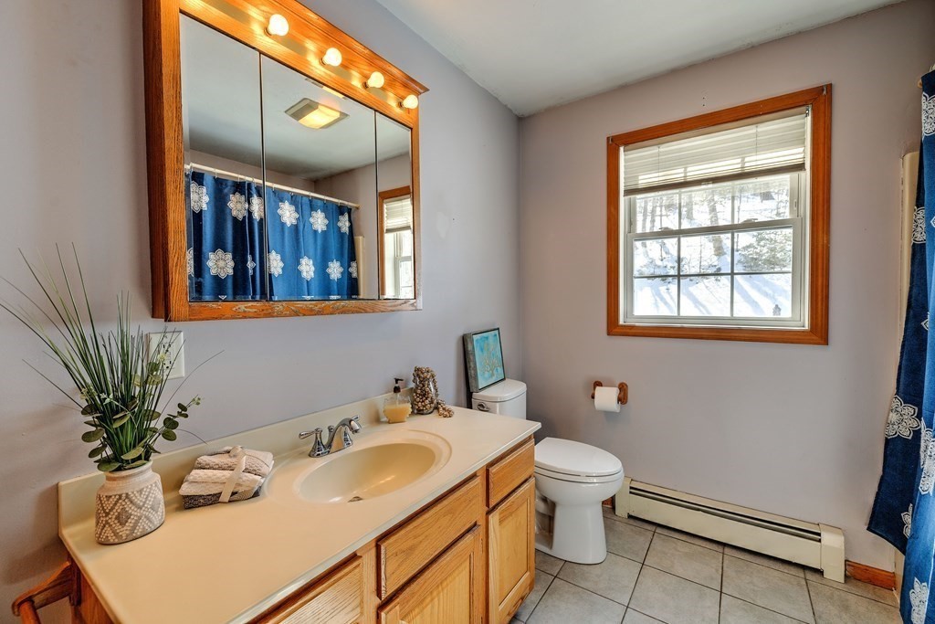 62 Vinton Road Holland, MA 01521 - Photo 25 of 37 a bathroom with a sink a toilet and a mirror
