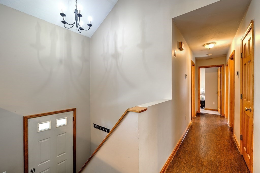 62 Vinton Road Holland, MA 01521 - Photo 10 of 37 a view of a hallway with wooden floor and staircase
