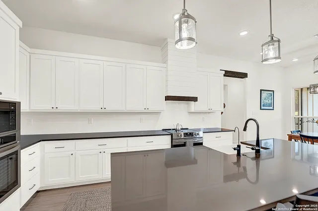 a kitchen with stainless steel appliances and refrigerator
