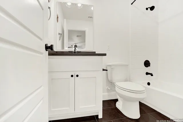 a view of a swimming pool with lawn chairs and a fire pit