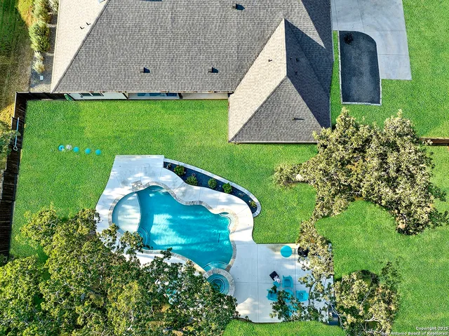 an aerial view of residential houses with outdoor space